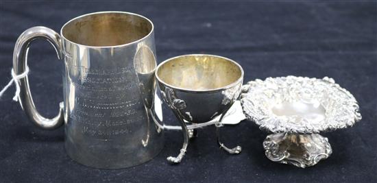 A silver presentation tankard, a small embossed silver circular pedestal dish and a circular silver salt, Total 9.65oz